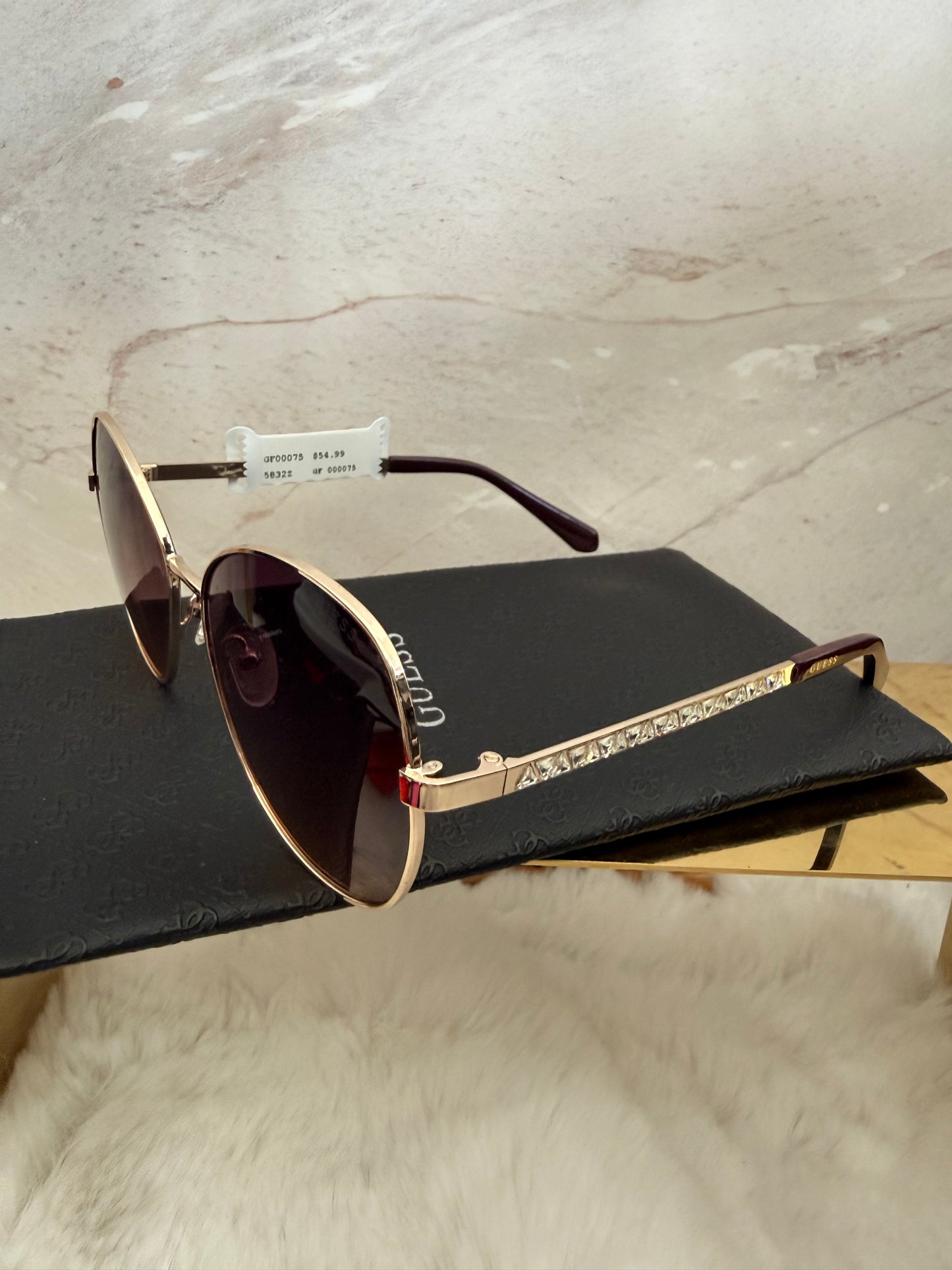 Lentes de dama armazón dorado con piedras a los lados  marca Guess con estuche de bolsa