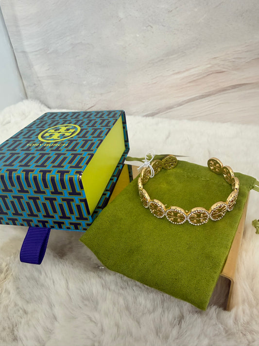 Pulcera de dama dorada marca Tory Burch